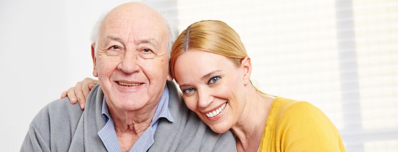 Happy family with woman embracing senior citizen man